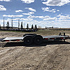 Black 2026 Rainbow Trailers 22' Excursion Tilt Deck Trailer